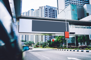 Empty gray banner over roadway in megapolis