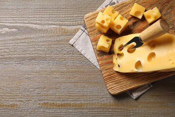 Tasty fresh cheese on wooden table, top view. Space for text