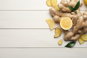 Fresh lemon and ginger on white wooden table, flat lay. Space for text