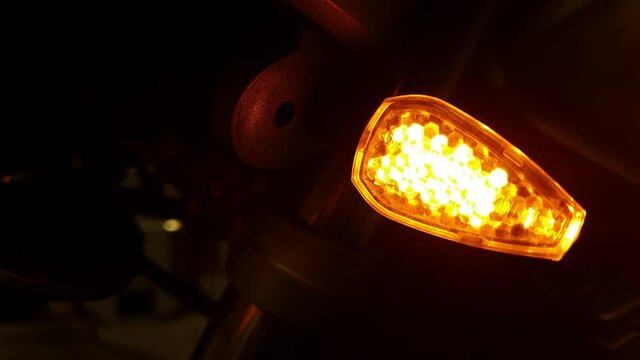 motorcycle turn signal blinking in the dark