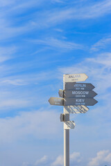Sign indicating the directions and distances to major cities in the world on observation deck on a top of Tahtali mountain near Kemer, Antalya Province in Turkey