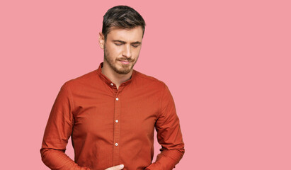 Handsome caucasian man wearing casual clothes with hand on stomach because indigestion, painful illness feeling unwell. ache concept.