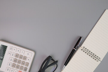 Office supplies that are commonly used on the desk such as pens, calculators, pencils, notebooks,...