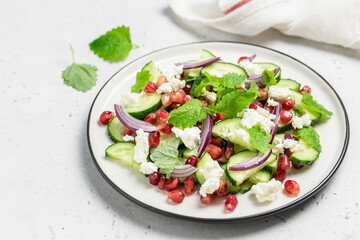 Summer fresh pomegranate cucumber salad, red onion mint vinegar gressing. Space for text.