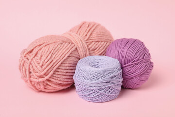 Fototapeta na wymiar Soft colorful woolen yarns on pink background