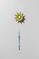 Concept of vaccination against coronavirus. Top view of syringe with vaccine against COVID-19 and...
