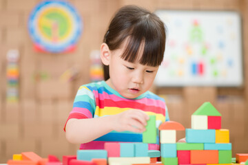  young girl playing creative toy blocks for homeschooling