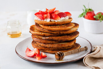Stack of french toast with cottage cheese, honey and strawberries for breakfast. Selective focus