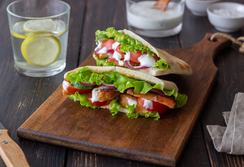 Pita with chicken, tomatoes, cucumbers, onions, salad and white sauce. Doner kebab. Healthy eating. Diet.