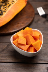 Sliced ripe papaya fruit on a white plate ready to eat