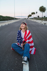 Chica joven atractiva rubia con bandera americana