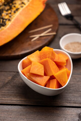 Sliced ripe papaya fruit on a white plate ready to eat