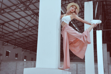 Asian blonde model in fashion shoot in a workshop