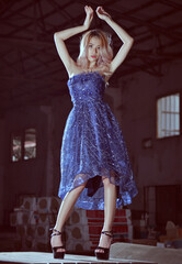 Asian blonde model in fashion shoot in a factory workshop