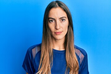 Obraz premium Young beautiful woman wearing casual clothes with serious expression on face. simple and natural looking at the camera.