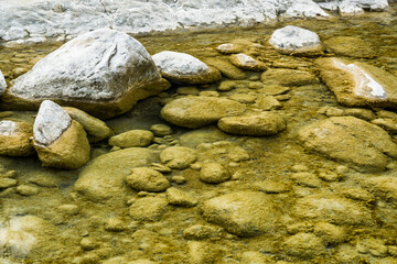 Fototapeta premium The stones under the pond, close-up as a background.