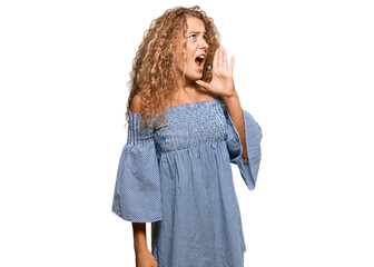 Beautiful caucasian teenager girl wearing summer dress shouting and screaming loud to side with hand on mouth. communication concept.