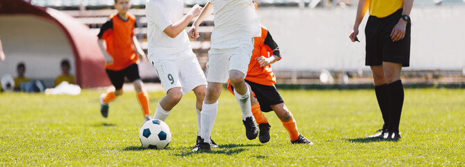 Running Football Players. School Soccer Teams Compete in Tournament Match. Young Football Players...