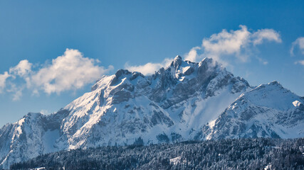 Fototapeta na wymiar Snow covered Mount Pilatus against blue sky with few clouds