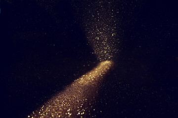 background of abstract gold and black glitter lights. defocused