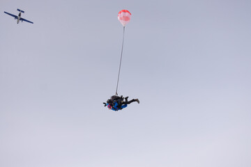 Obraz na płótnie Canvas Skydiving. Tandem jump. Man and woman. Winter season.