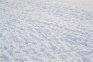 Trampled light white snow, footprints texture.  Snowy winter park. Minimalism