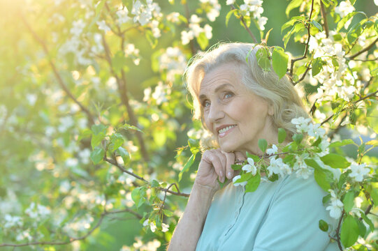 Happy senior beautiful woman in spring park