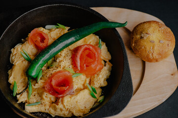 Delicious smoked fish fillet prepared in various ways and arranged on different plates with tasty healthy burger and salad meals