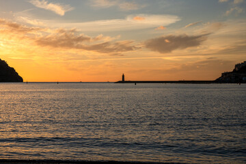 Obraz premium Beautiful sunset in Puerto de Andratx with a lighthouse in the background. Palma de Mallorca, Spain