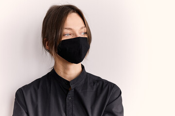 Obraz premium European girl in black shirt and mask