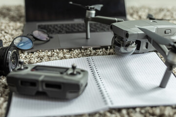 Travel accessories. Drone, notebook, smartphone and laptop, camera and glasses. Top view