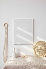 Fototapeta na wymiar White frame mockup with macrame and straw bag