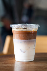 Iced latte coffee glass on wooden table.