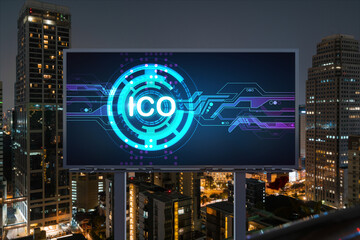 ICO hologram icon on billboard over panorama city view of Bangkok at night time. The hub of blockchain projects in Southeast Asia. The concept of initial coin offering, decentralized finance