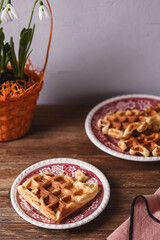 Homemade Belgian Waffles served with condensed milk on wooden background. Breakfast. Selective focus