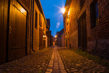 A small narrow alley in an old village at night, Beelitz, Brandenburg, Germany