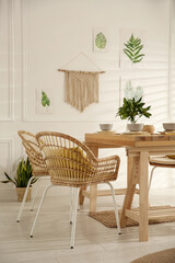 Stylish wooden dining table and chairs in room. Interior design