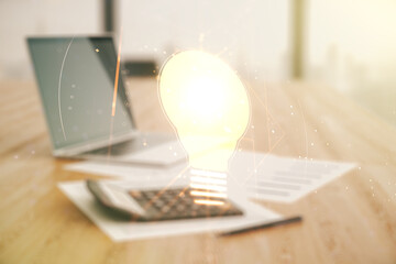 Virtual Idea concept with light bulb illustration on calculator and laptop background. Multiexposure