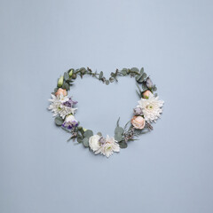 Beautiful heart made of different flowers on light gray background, flat lay. Space for text