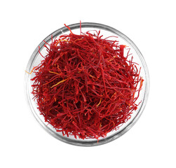 Fototapeta premium Aromatic saffron in glass bowl isolated on white, top view