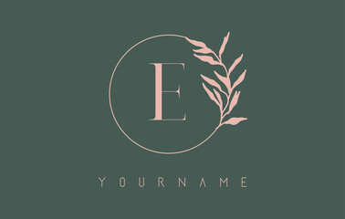 E Letter logo design with dust pink circle and leaves on a green background. Initial Letter E Vector Illustration with Botanical elements.