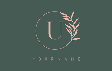U Letter logo design with dust pink circle and leaves on a green background. Initial Letter U Vector Illustration with Botanical elements.