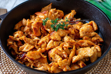 frying pan with fried chicken breast
