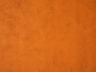 red textured stucco wall background. red stucco wall. Background of a red stucco coated and painted exterior, rough cast of cement and.red background. abstract pastel wall grunge stone. 