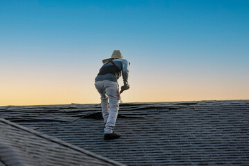 roofer removing roof nails with roof shingle remover © Kathy images
