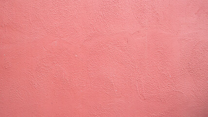 Fototapeta premium Pink textured stucco wall background. Pink stucco wall. Background of a pink stucco coated and painted exterior, rough cast of cement and.pink background. abstract pastel wall grunge stone.