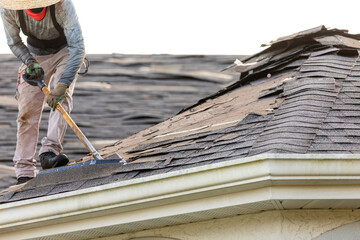 roofer removing roof nails with roof shingle remover © Kathy images
