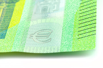 Obraz premium Macro shot of a European Union banknote of 100 EUR, close-up on the symbol of EURO, selective focus.