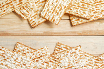 Background for the traditional Jewish holiday Pesach. Passover matzo bread on a wooden table. Matzoh frame. Place for your text.
