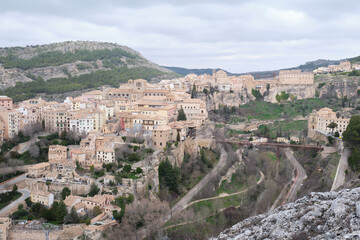 Fototapeta na wymiar View of Hanged Houses (Casas Colgadas) and San Pablo bridge in Cuenca (Spain) taking from a hill.